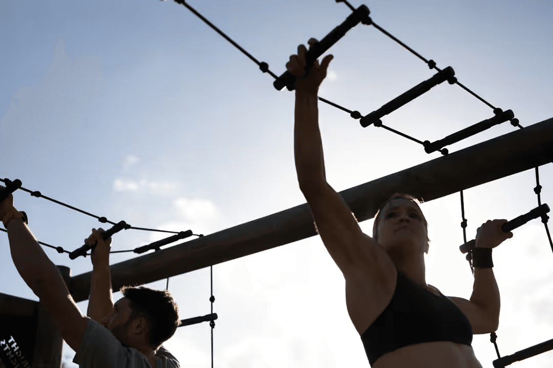 Low angle image of two people training on rope ladder monkey bars - How to make a beautiful digital vision board with free online tools in 5 steps - Image