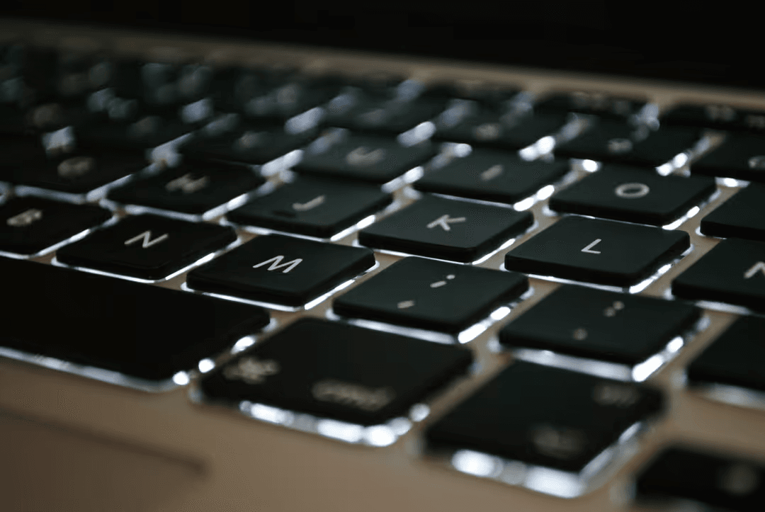 Close up image of a black keyboard of a laptop - Expert online marketing tips to improve your digital strategy and make more money - Image