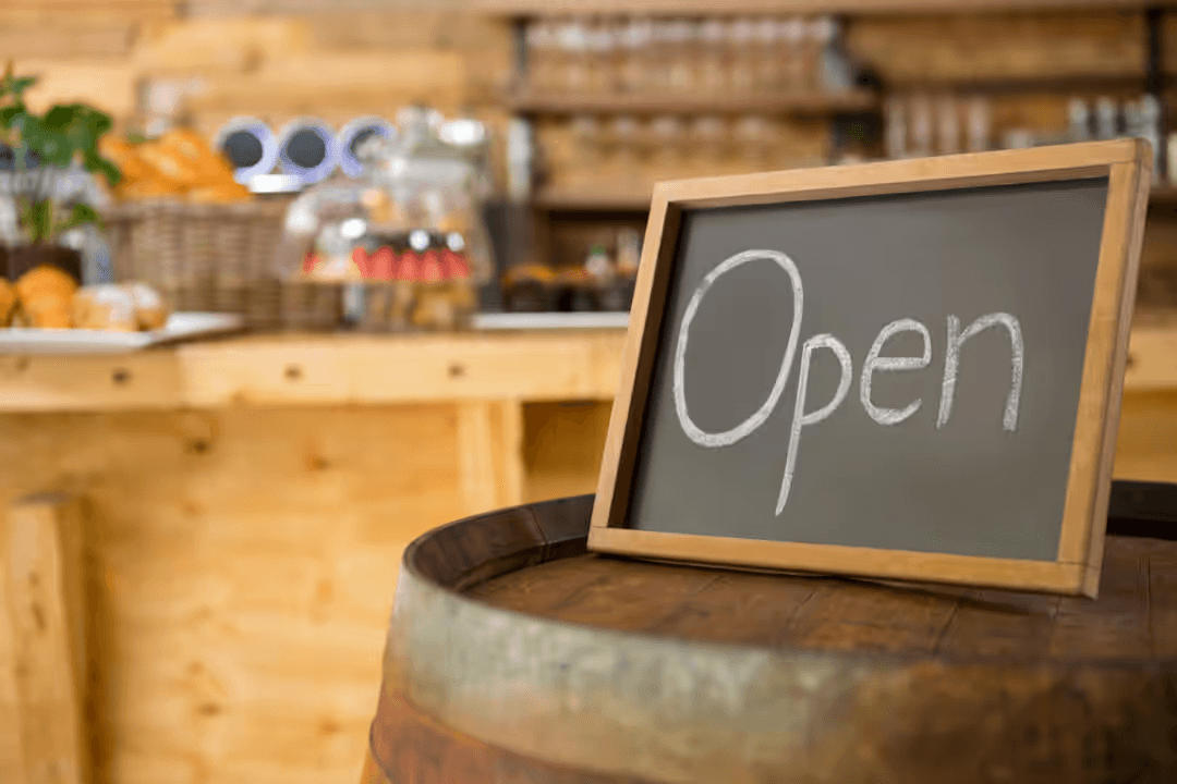 Image of an open sign in a restaurant - Retail marketing strategy tips and tricks to drive sales and save money - Image