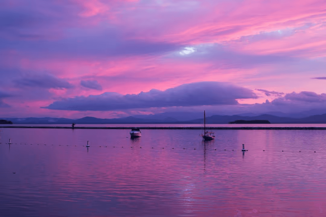 Purple sunset with boats in the water with clouds - How to create a perfect modern color scheme for your website - Image