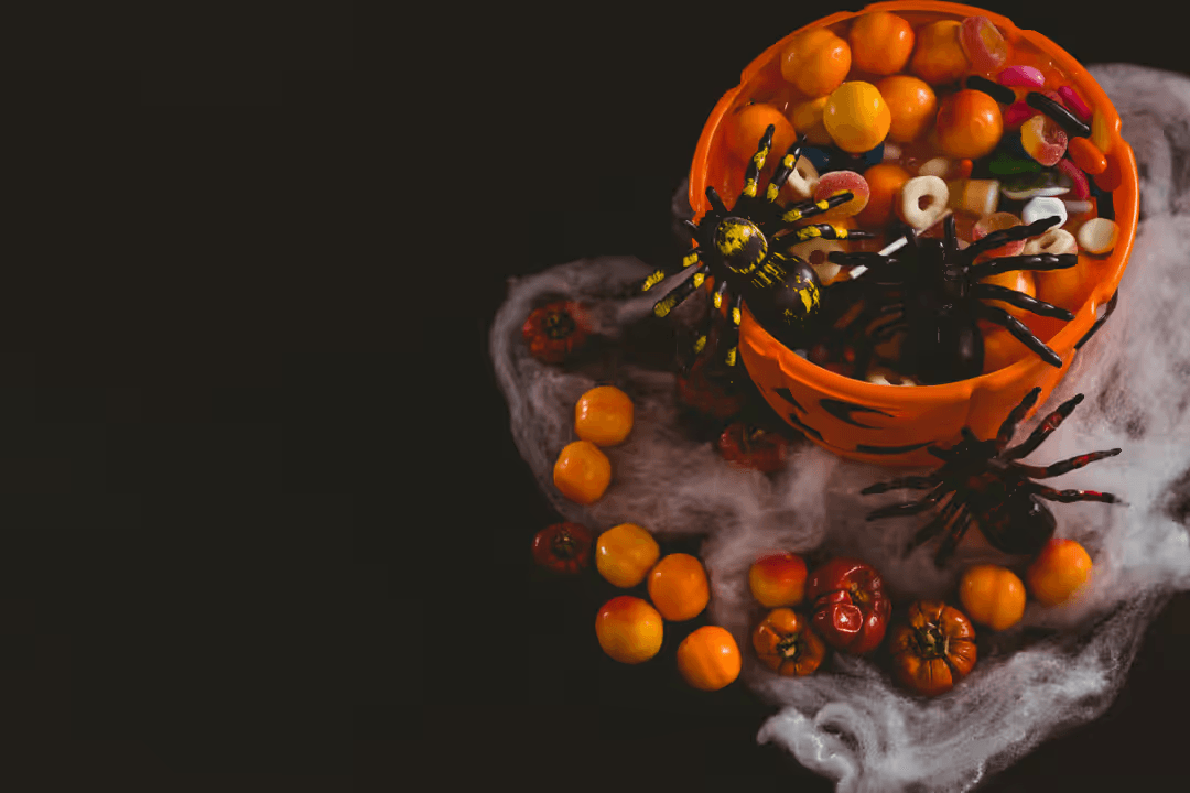 Image of a bucket with treats for the kids on Halloween - A selection of engaging Halloween images from the PikWizard team - Image
