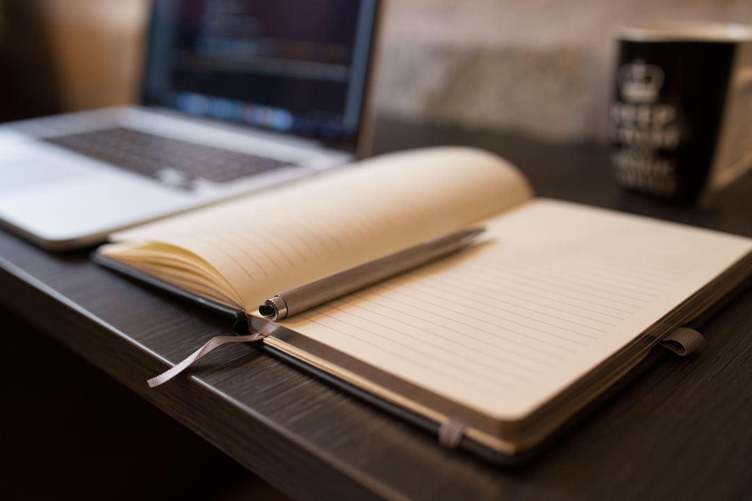 Image of a notebook with a pen on a desk  - A selection of images from the PikWizard team on the eve of the New Year - Image