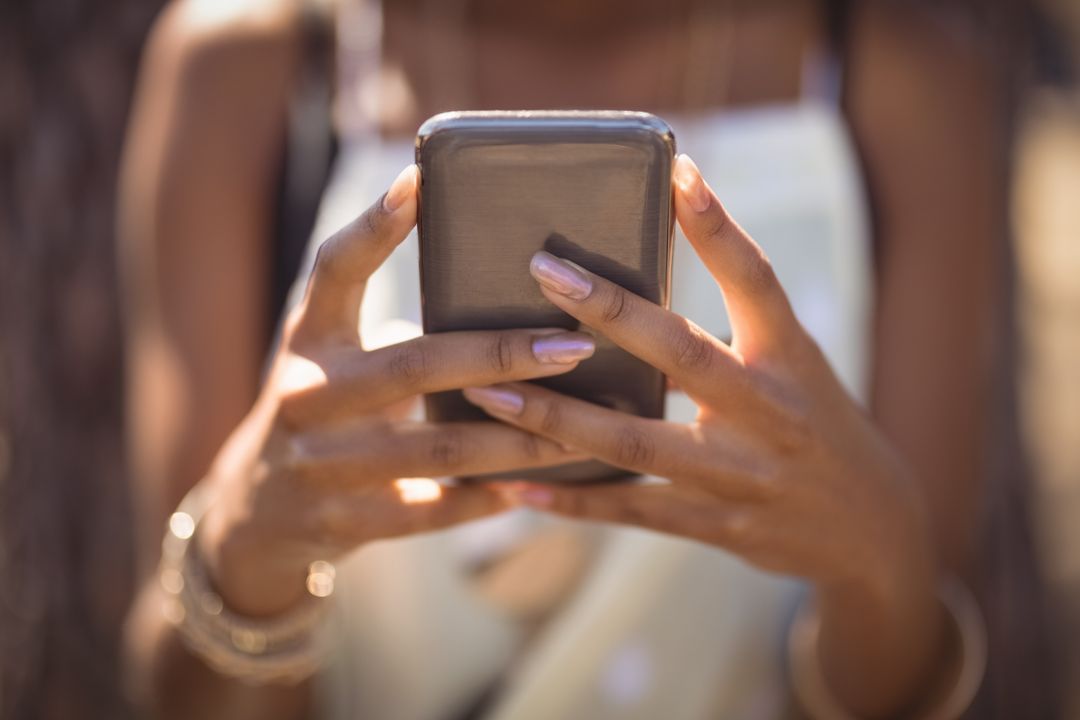 Image of a woman holding her smartphone with both hands - The beginner's guide to YouTube marketing, how to increase subscribers quickly - Image