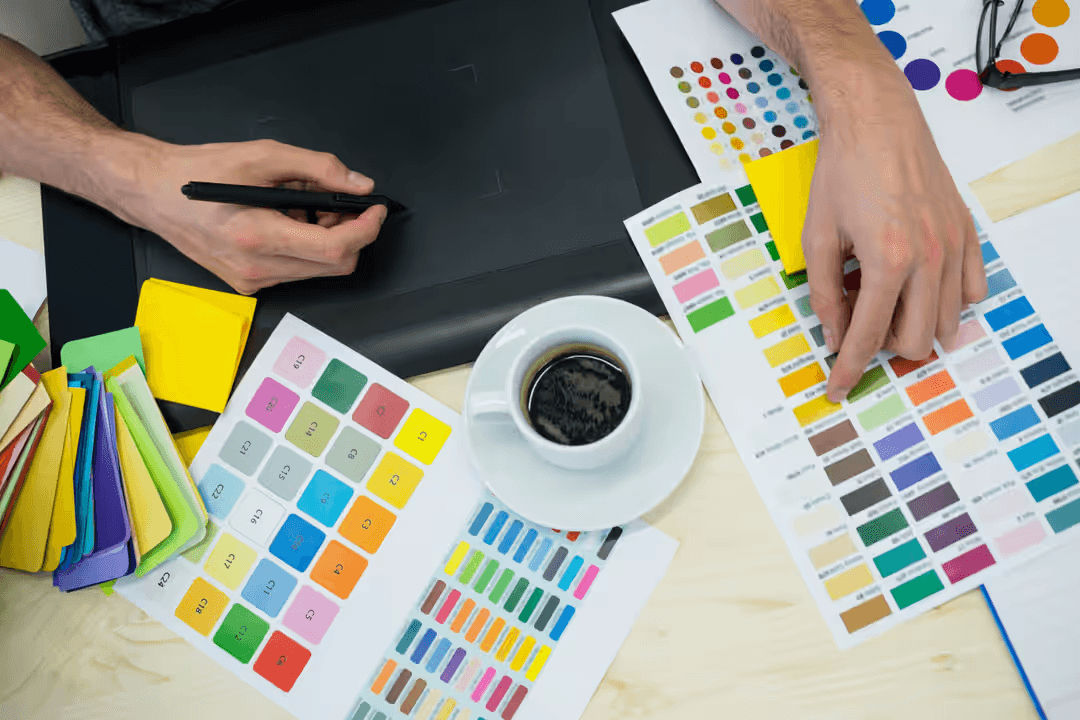 Image of a man working on a tablet with notes on the desk - Six types of graphics you need to know for business marketing - Image