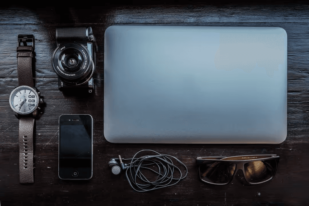 Image of a computer, camera, smartphone, watch on a desk - Six types of graphics you need to know for business marketing - Image