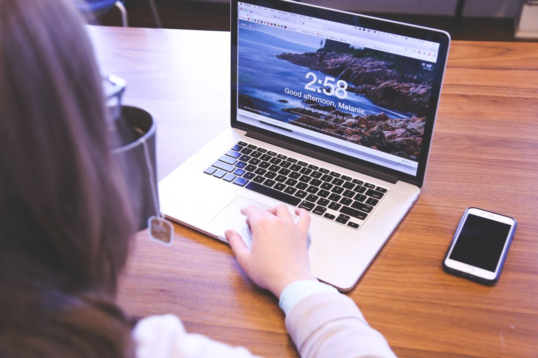 Image of a woman working on a macbook - Social media strategy to increase conversions - Image