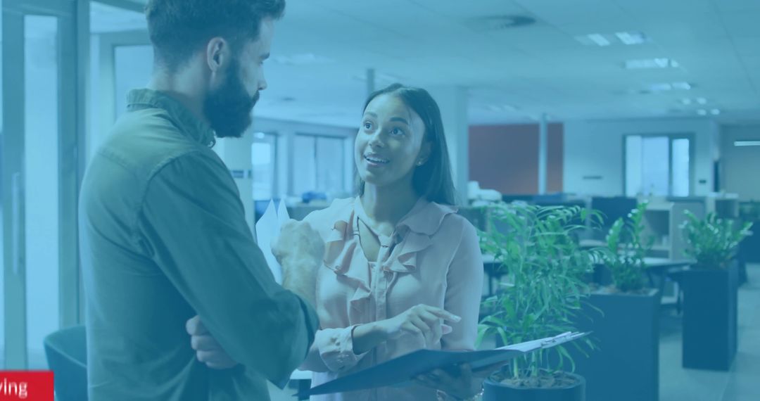 Two Professionals Collaborating in Modern Open-Plan Office Space