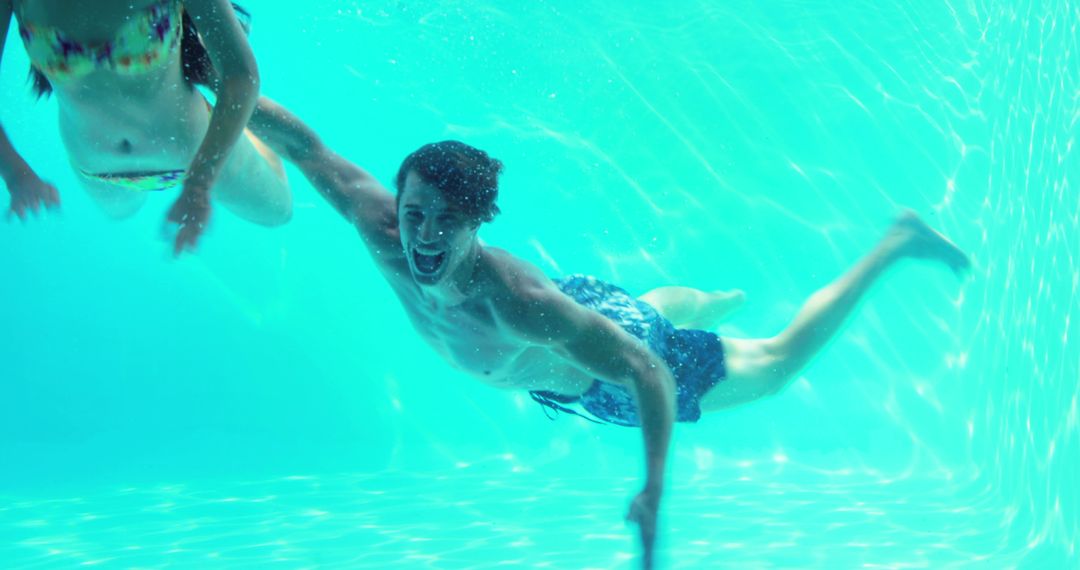 Underwater Adventure with Joyful Swimmers in Pool