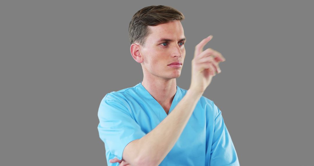 Male Nurse Interacting with Virtual Screen Isolated on Gray Background - Free Images, Stock Photos and Pictures on Pikwizard.com