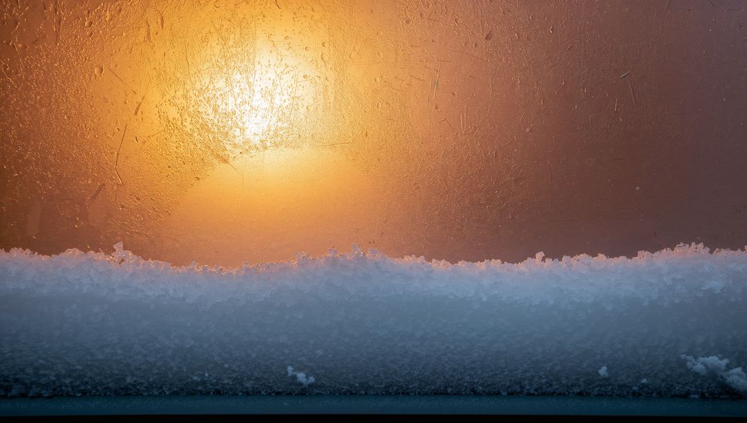 Sunlit Frosted Window Sill with Snow Ridge and Warm Amber Backlight, Closeup Texture