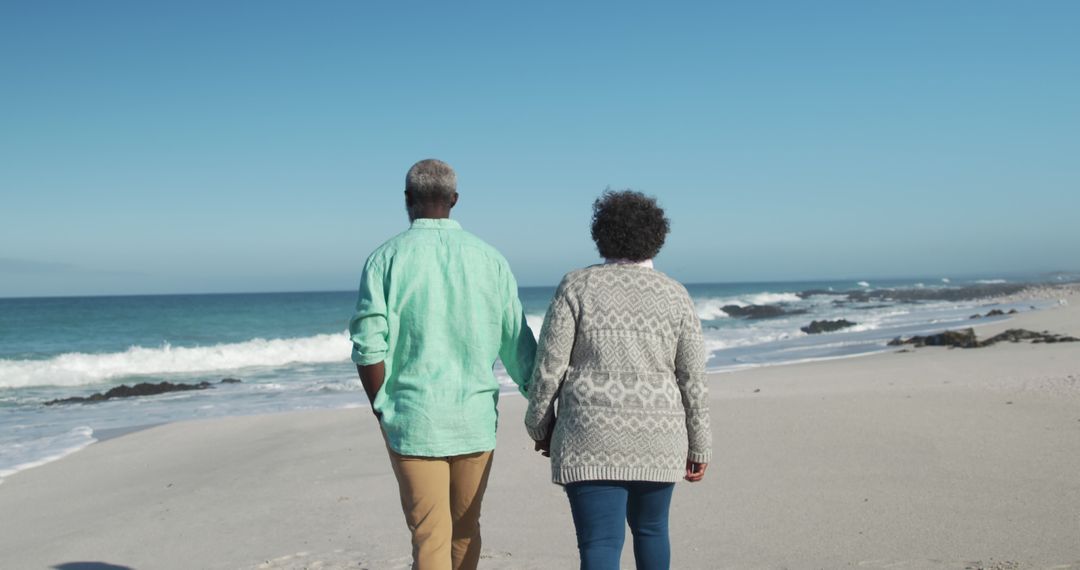 African american senior couple holding hands on beach by seaside with copy space - Free Images, Stock Photos and Pictures on Pikwizard.com