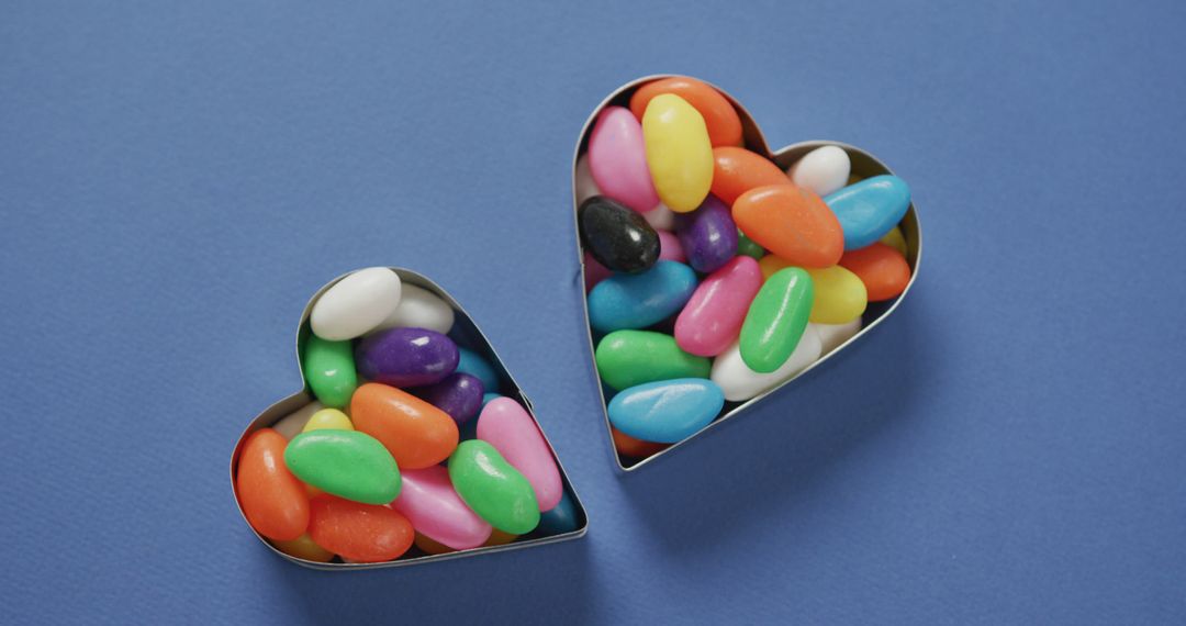 Colorful Jelly Beans in Heart-Shaped Containers on Blue Background - Free Images, Stock Photos and Pictures on Pikwizard.com