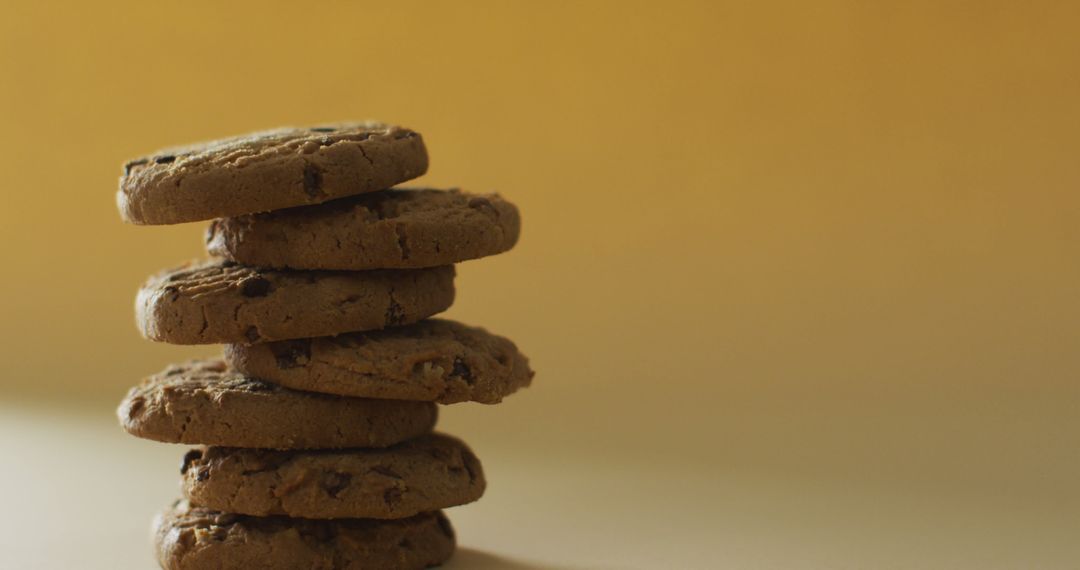 Stack of Chocolate Chip Cookies on Warm Yellow Background - Free Images, Stock Photos and Pictures on Pikwizard.com