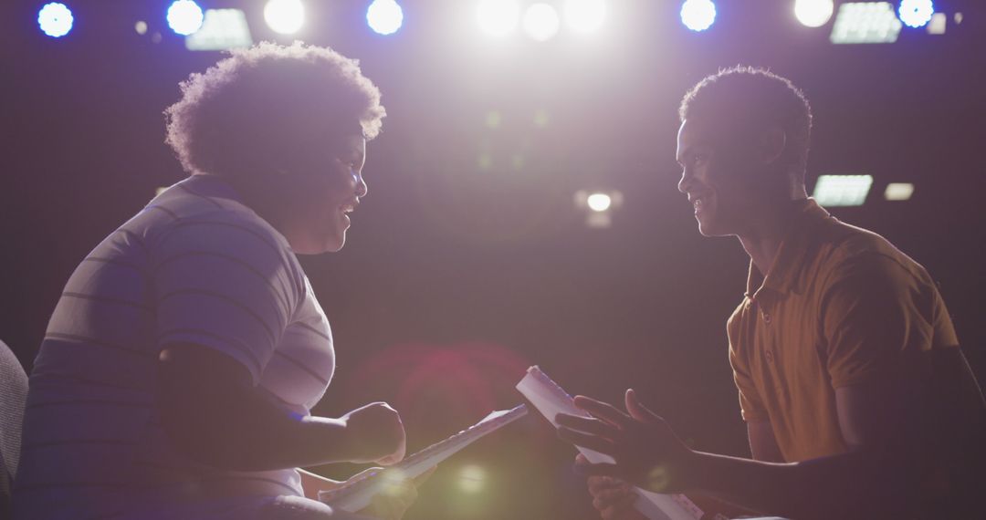 Actors Rehearsing Script Under Stage Lights - Free Images, Stock Photos and Pictures on Pikwizard.com