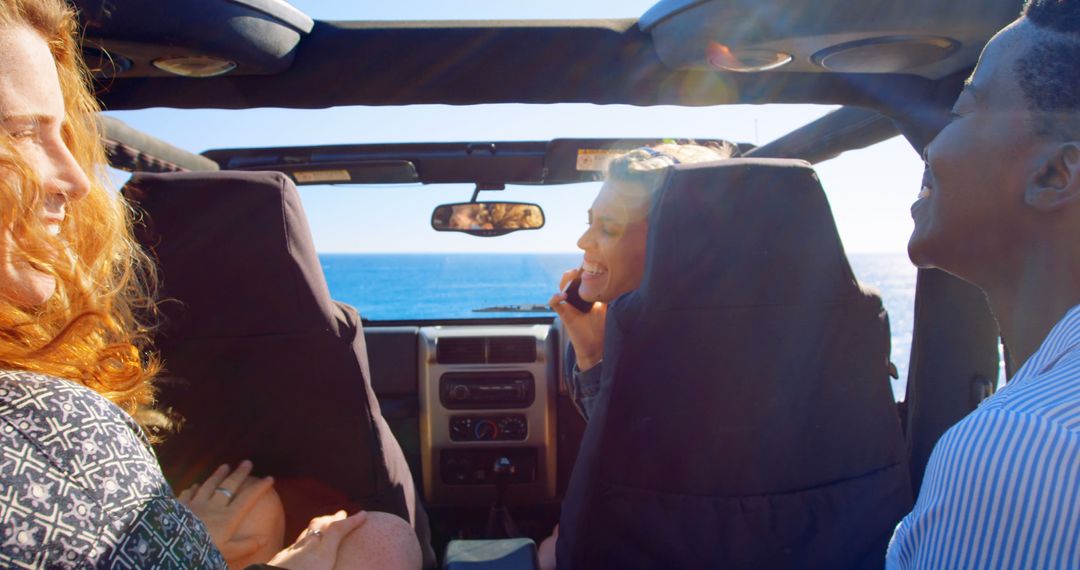 Friends Enjoying Road Trip in Convertible with Ocean Background - Free Images, Stock Photos and Pictures on Pikwizard.com