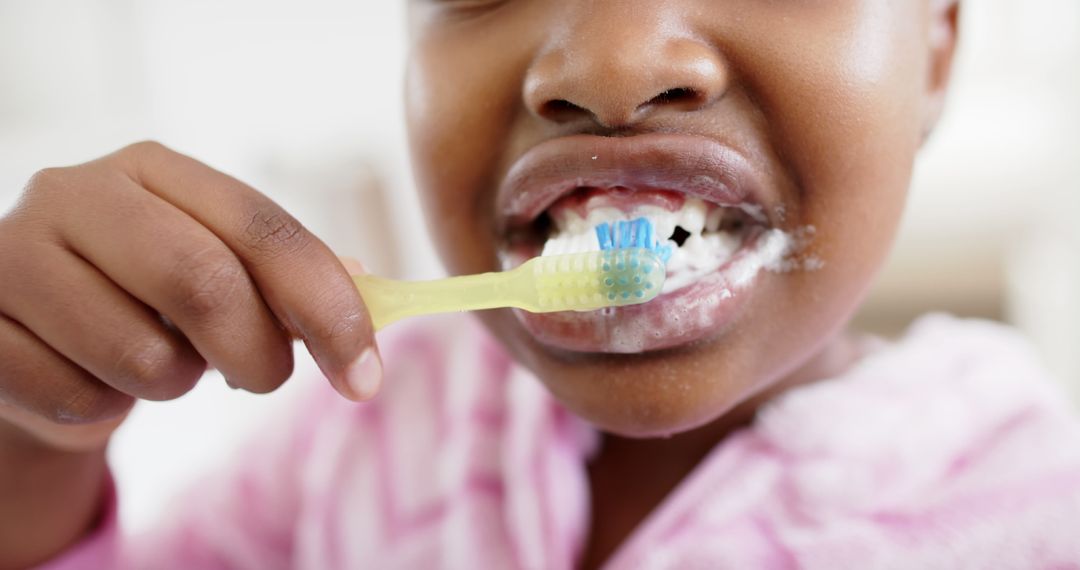 Close-Up of Child Brushing Teeth with Toothbrush and Toothpaste - Free Images, Stock Photos and Pictures on Pikwizard.com