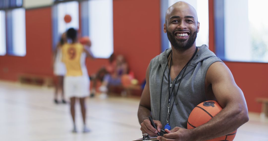 Basketball Coach Smiling in Indoor Court - Free Images, Stock Photos and Pictures on Pikwizard.com