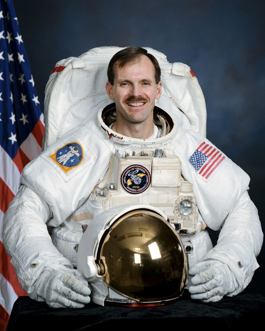 Official portrait of Astronaut Steve Smith wearing an EMU - Free Images, Stock Photos and Pictures on Pikwizard.com