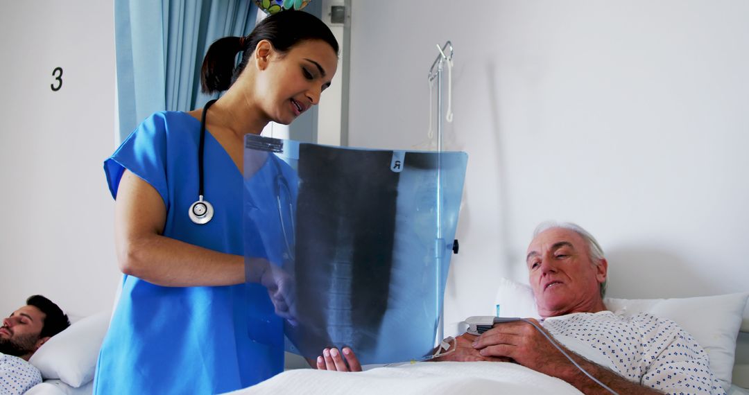 Nurse Showing X-Ray to Elderly Patient in Hospital Bed - Free Images, Stock Photos and Pictures on Pikwizard.com