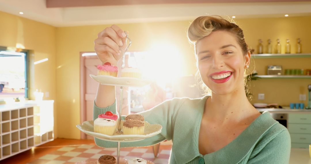 Smiling Woman Enjoying Cupcakes in Sunlit Kitchen - Free Images, Stock Photos and Pictures on Pikwizard.com