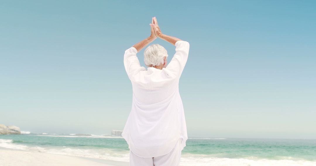 Senior Woman Practicing Yoga on Tranquil Beach - Free Images, Stock Photos and Pictures on Pikwizard.com