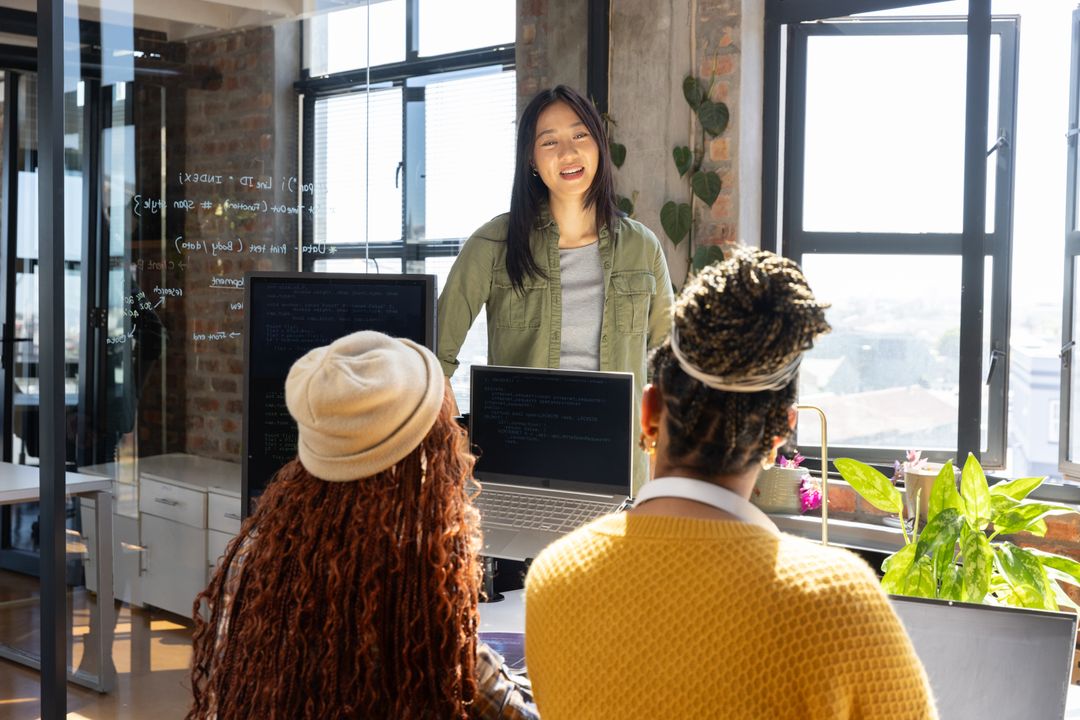 Diverse Female Team Collaborating on Software Development Project
