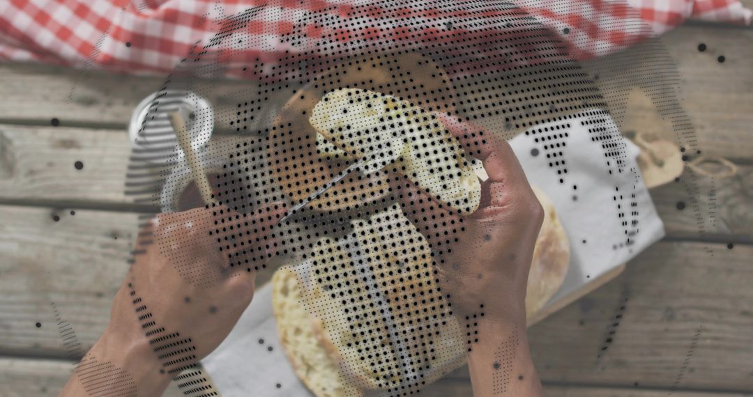 Hands Pulling Rustic Flatbreads during Outdoor Picnic on Wooden Table with Gingham Cloth