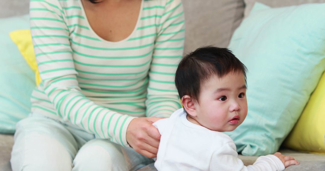 Mother Comforting Asian Toddler in Cozy Home Environment - Free Images, Stock Photos and Pictures on Pikwizard.com