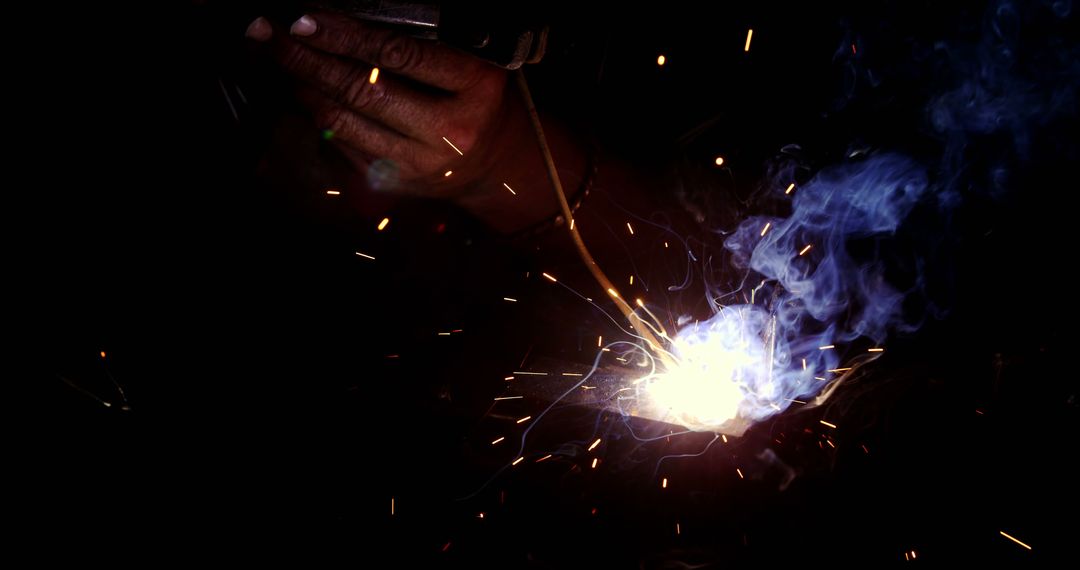 Close-up of Welding Sparks and Smoke in Dark Workshop - Free Images, Stock Photos and Pictures on Pikwizard.com