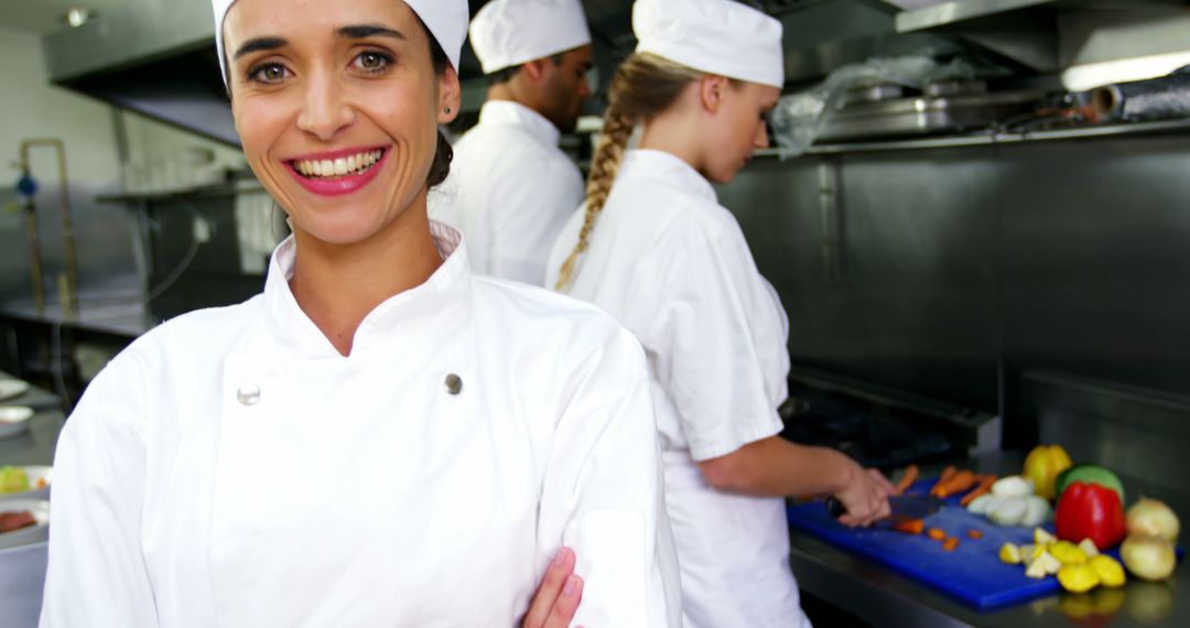 Smiling Chef Posing in Professional Restaurant Kitchen - Free Images, Stock Photos and Pictures on Pikwizard.com