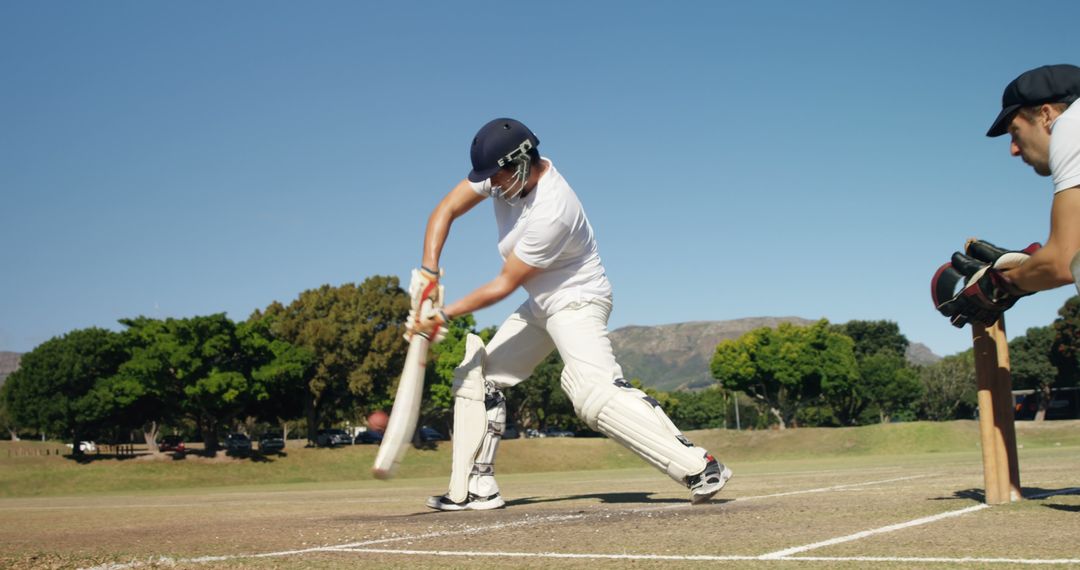 Amateur Cricket Player Hitting Ball Outdoors on Sunny Day - Free Images, Stock Photos and Pictures on Pikwizard.com