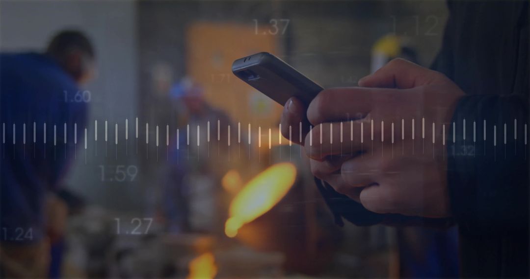 Technician Using Smartphone in Industrial Workshop with Furnace