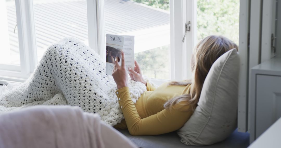 Woman Relaxing with Book by Window at Home - Free Images, Stock Photos and Pictures on Pikwizard.com