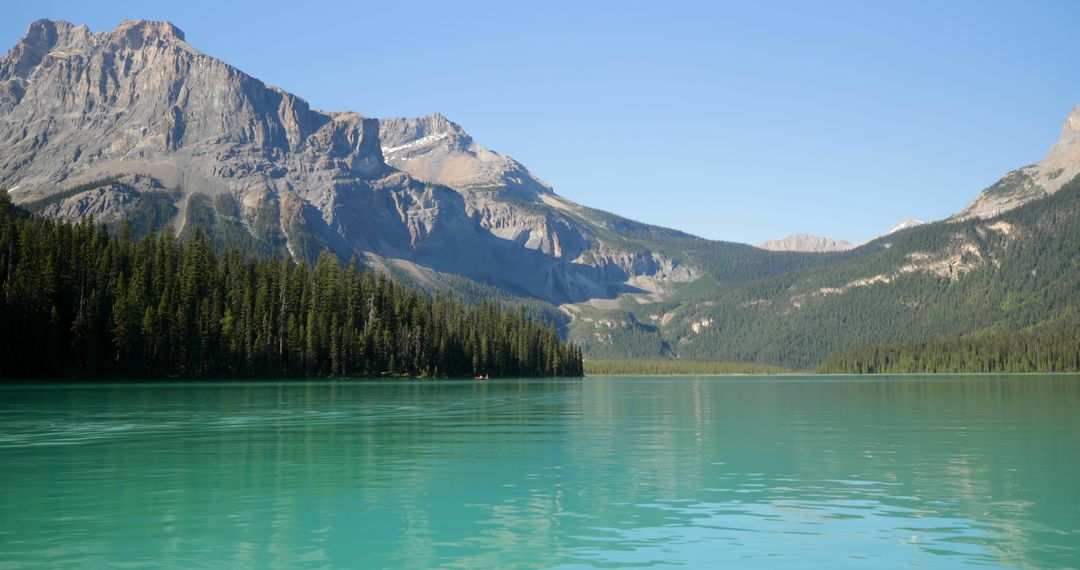 Scenic Turquoise River with Majestic Mountains on a Sunny Day - Free Images, Stock Photos and Pictures on Pikwizard.com