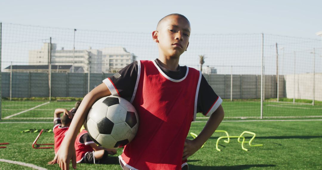 Confident Young Soccer Player Holding Ball on Field - Free Images, Stock Photos and Pictures on Pikwizard.com