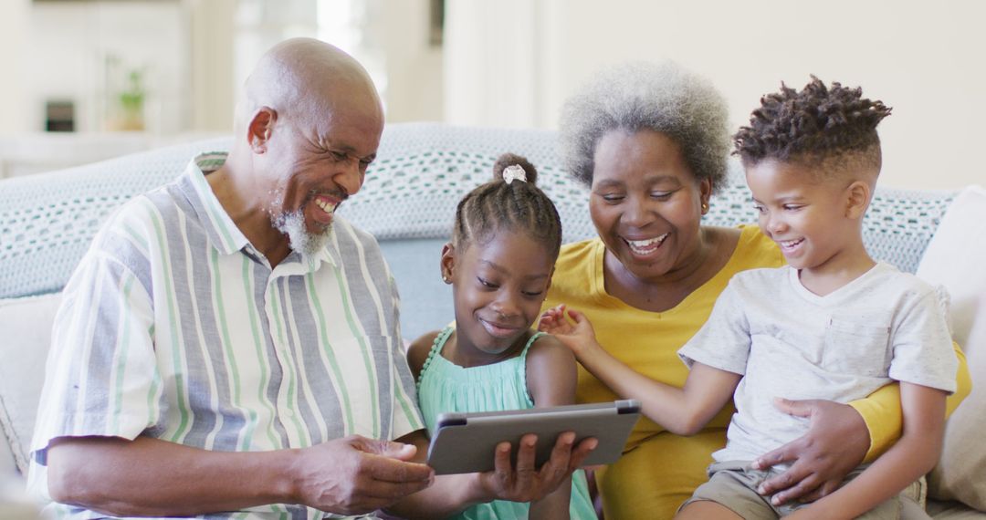 Senior Couple Enjoying Time with Grandchildren on Digital Tablet - Free Images, Stock Photos and Pictures on Pikwizard.com