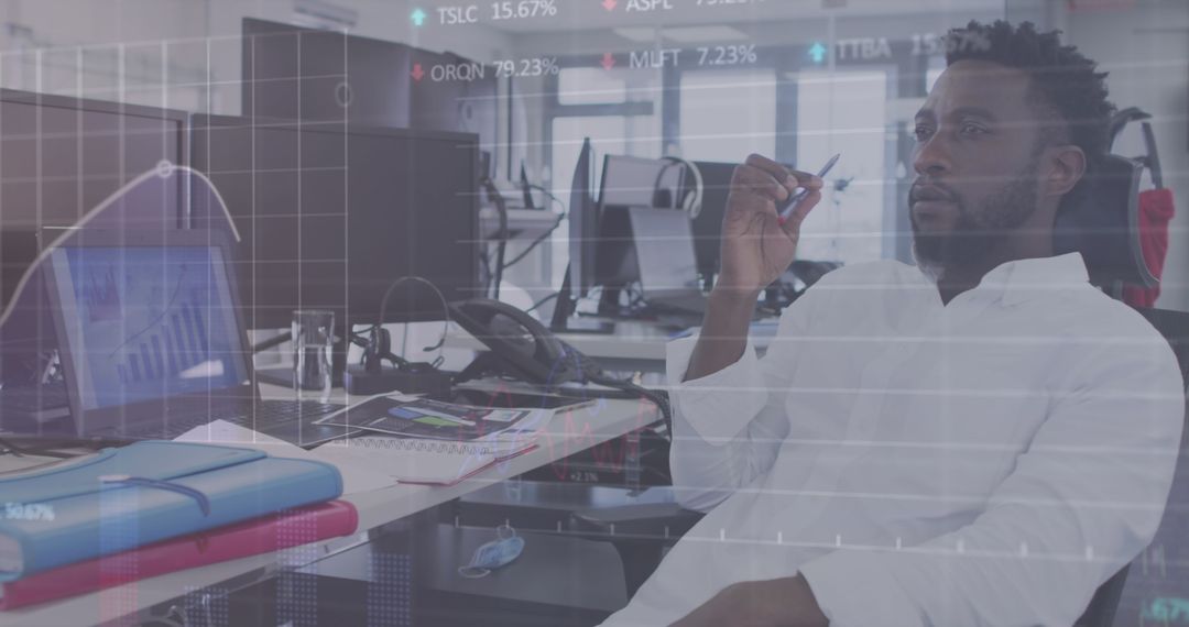 Businessman Analyzing Data with Digital Interface Overlay in Office