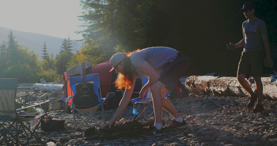 Friends Preparing Camping Site at Sunrise Outdoors - Free Images, Stock Photos and Pictures on Pikwizard.com