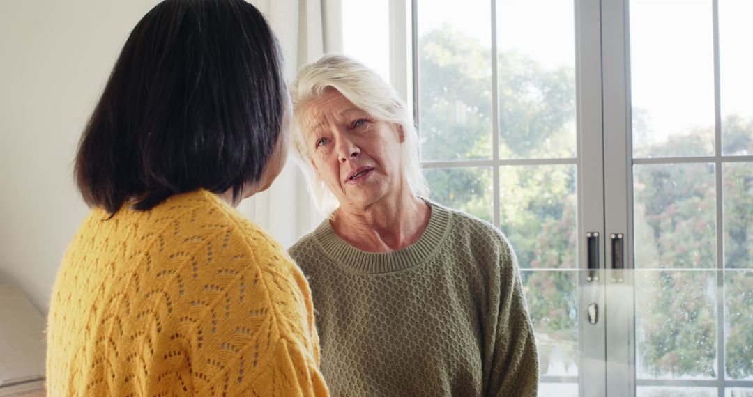 Elderly Woman Engaging in Calm Conversation with Friend at Home