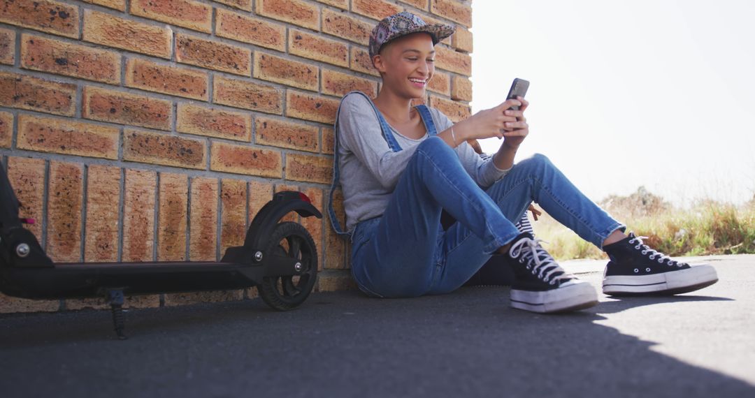 Teen Girl Urban Leisure Relaxing with Phone Outdoors by Scooter - Free Images, Stock Photos and Pictures on Pikwizard.com