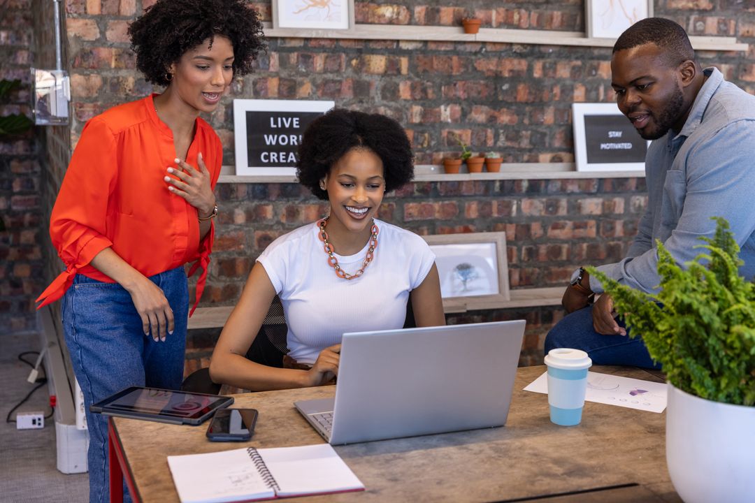 Diverse Coworkers Collaborating in Modern Creative Office