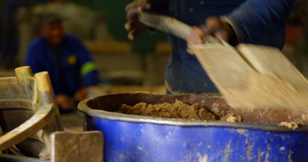 Close-up of worker putting soil in bucket with shovel - Free Images, Stock Photos and Pictures on Pikwizard.com