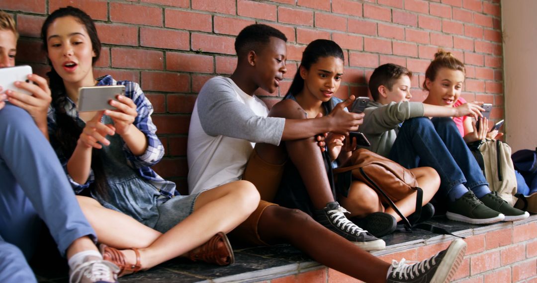 Group of Teenagers Sitting Outdoors Texting on Smartphones - Free Images, Stock Photos and Pictures on Pikwizard.com