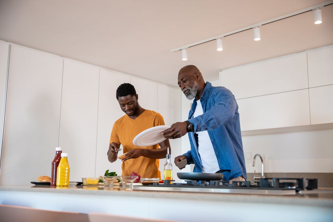 Father and Son Cooking Together in Modern Home Kitchen