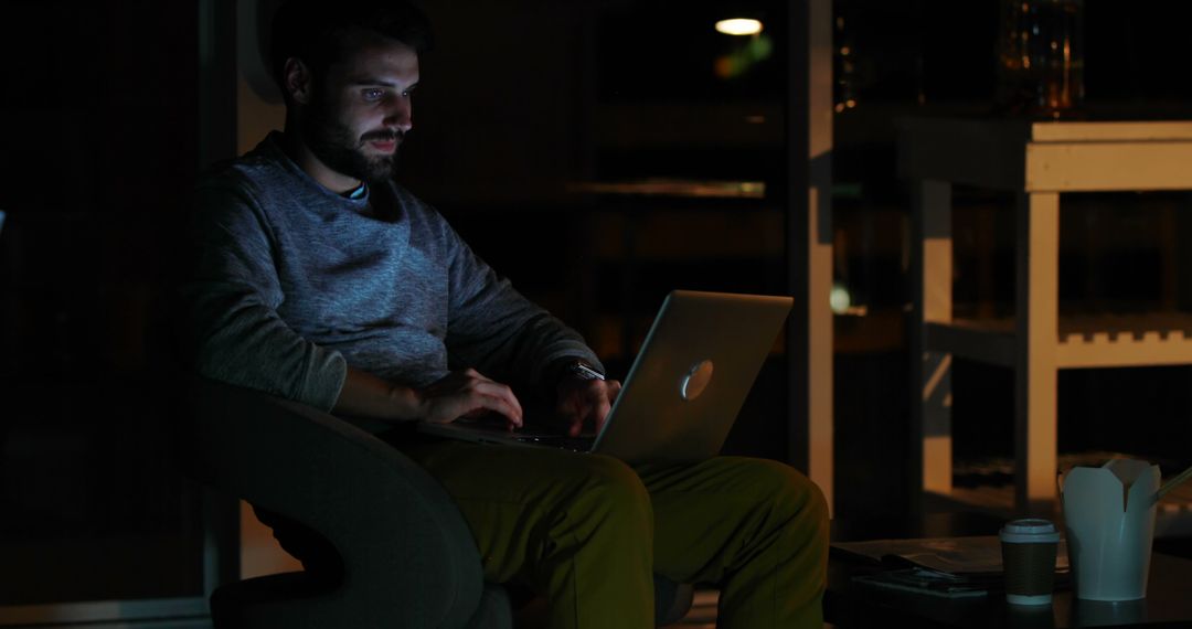 Man working on laptop in dark room at night - Free Images, Stock Photos and Pictures on Pikwizard.com