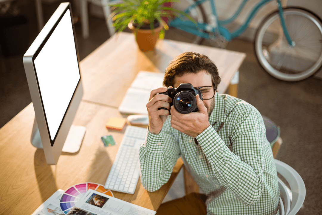 Creative Photographer Charging Moment at Desk with Transparent Long Eyeglasses