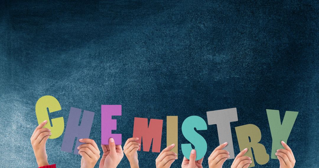 Hands Holding Colorful Chemistry Word Cutouts in Classroom