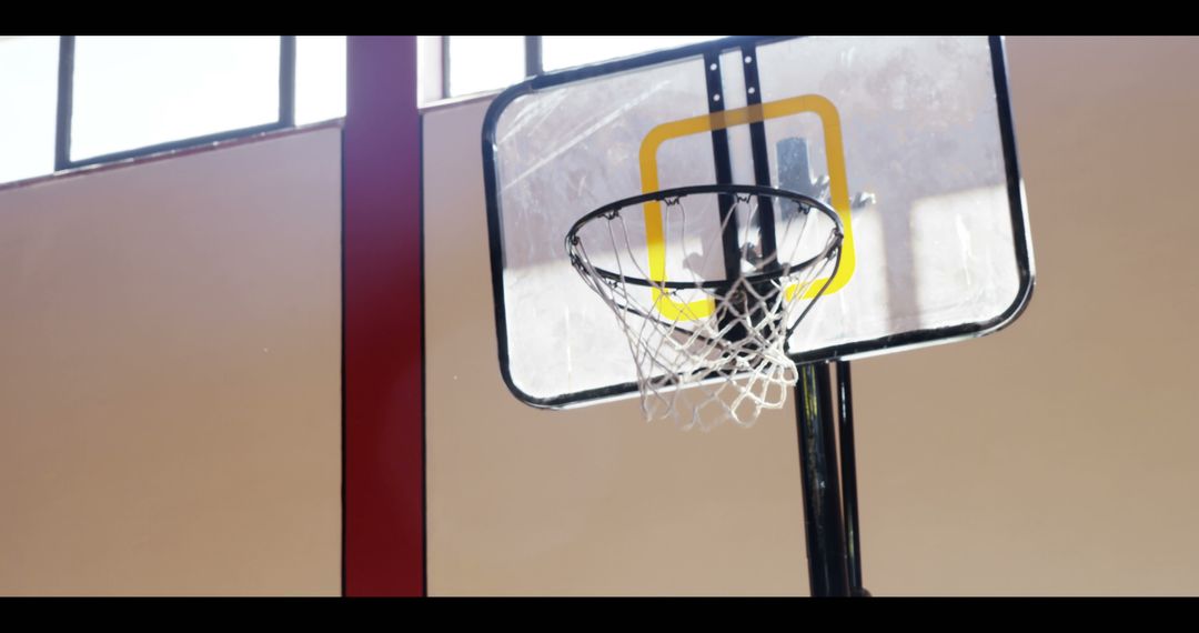 Basketball Hoop in Sunlit Gymnasium - Free Images, Stock Photos and Pictures on Pikwizard.com