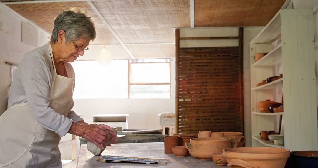 Senior Woman Working with Clay in Pottery Studio - Free Images, Stock Photos and Pictures on Pikwizard.com