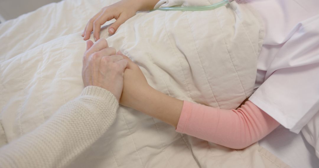 Close-Up of Comforting Hand Hold in Hospital Bed - Free Images, Stock Photos and Pictures on Pikwizard.com